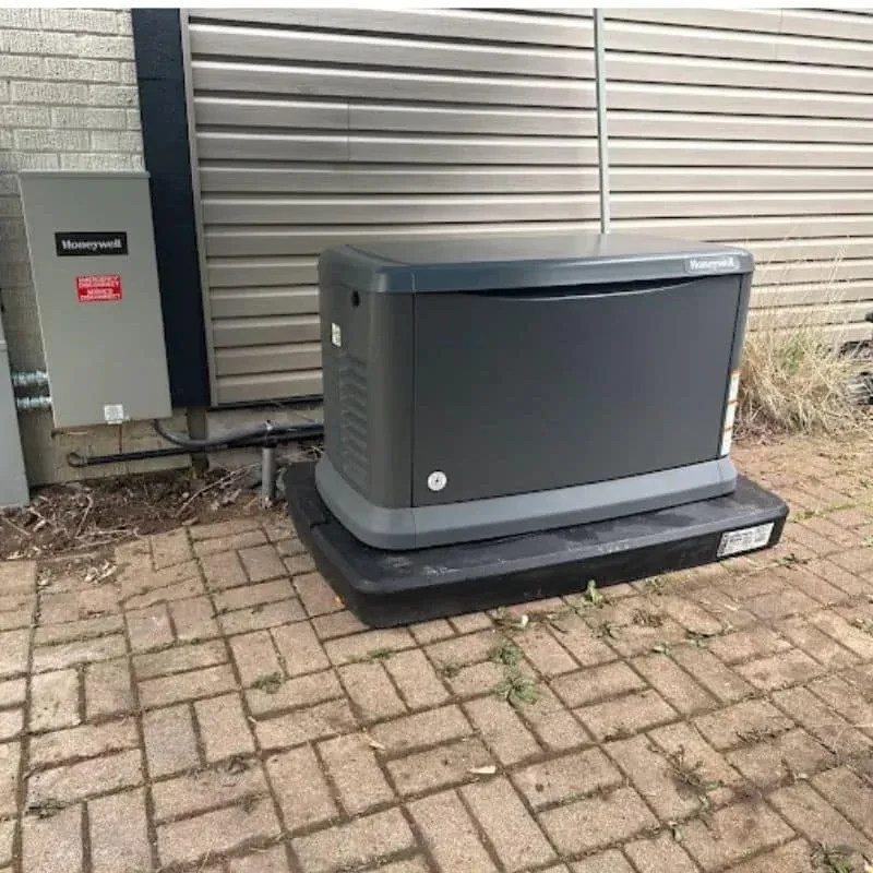 Honeywell standby generator and transfer equipment installed beside a home