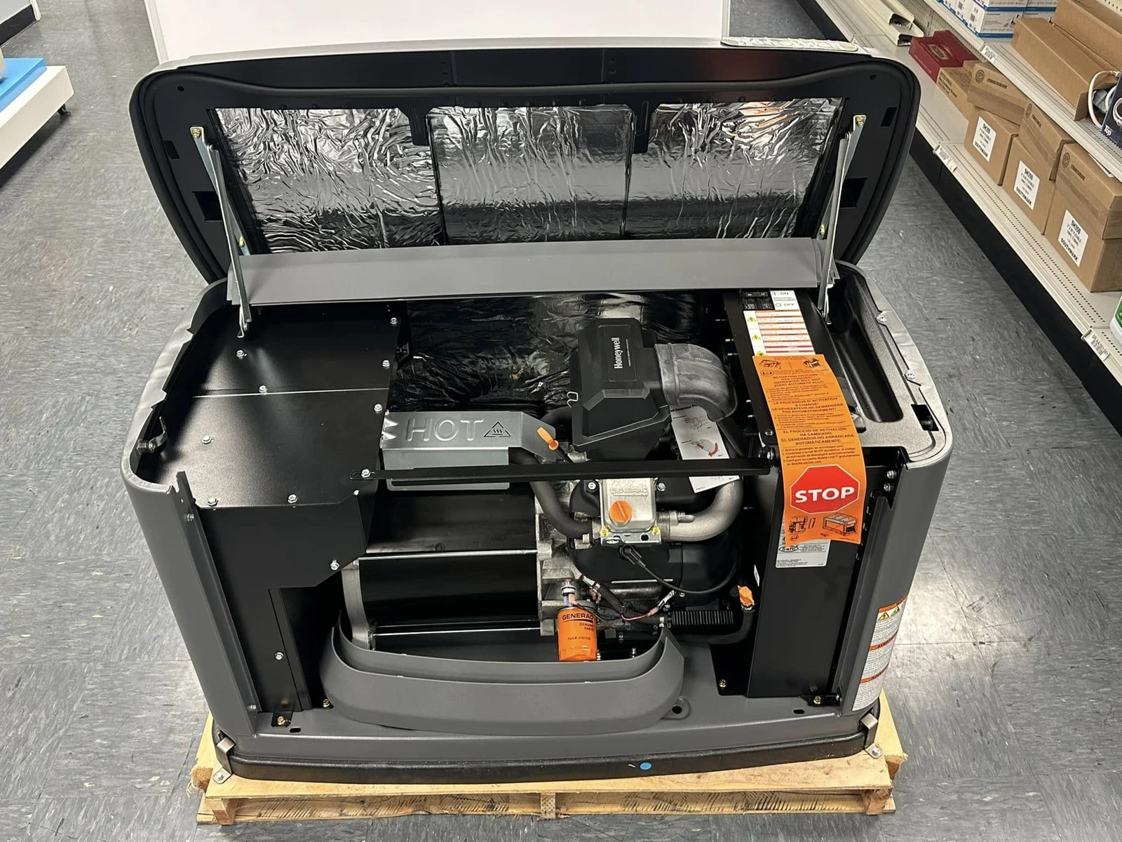 Honeywell standby generator in a workshop with its lid open and front panel removed