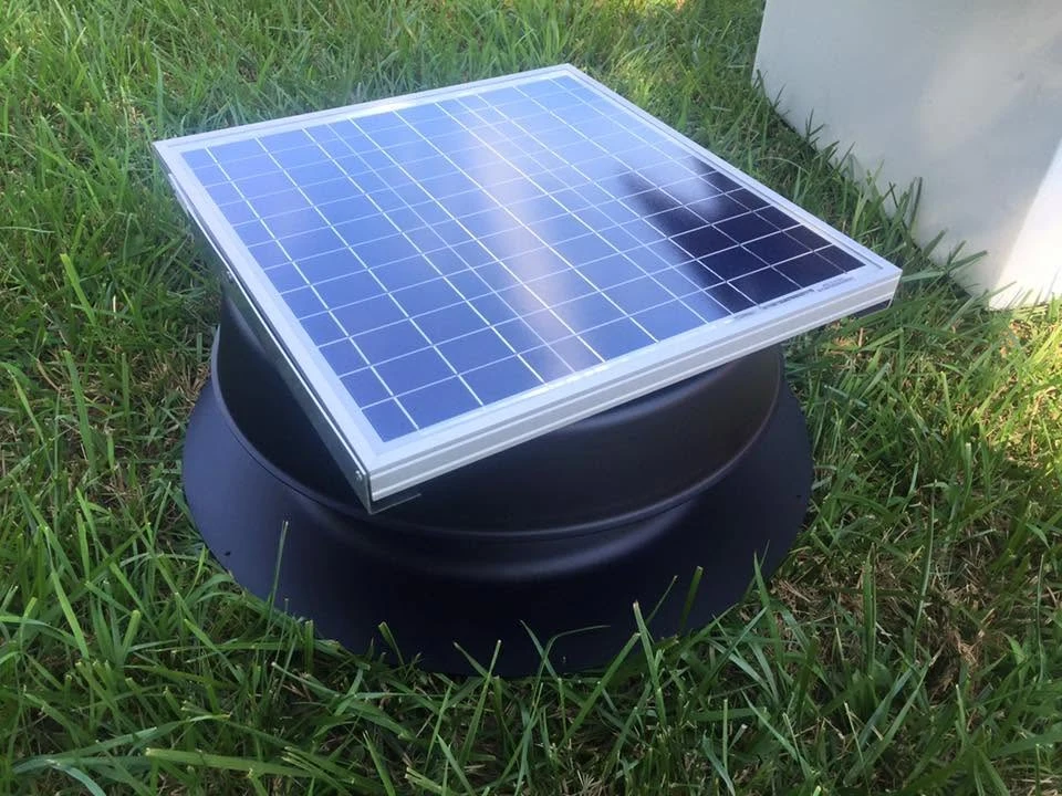 A solar-powered attic fan with a panel mounted above its housing